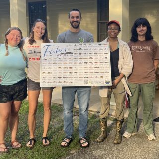 Aquatic Science Lab members showing off the poster.